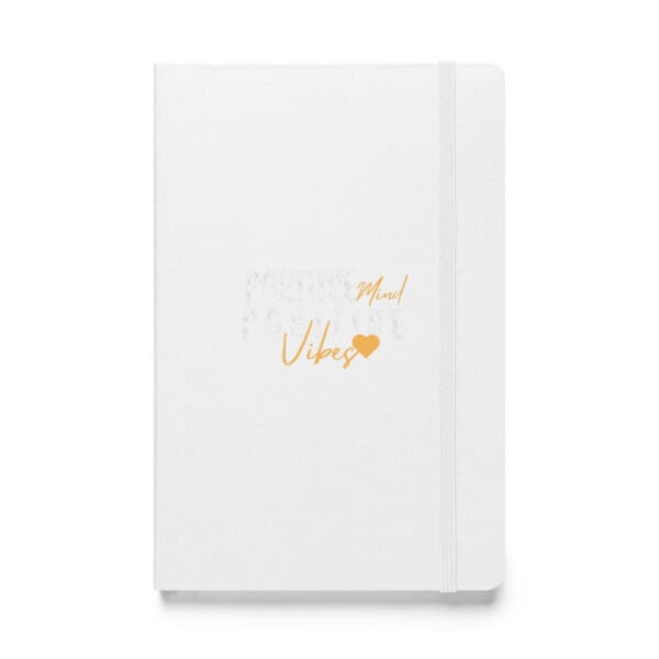 A white notebook with orange writing on it.