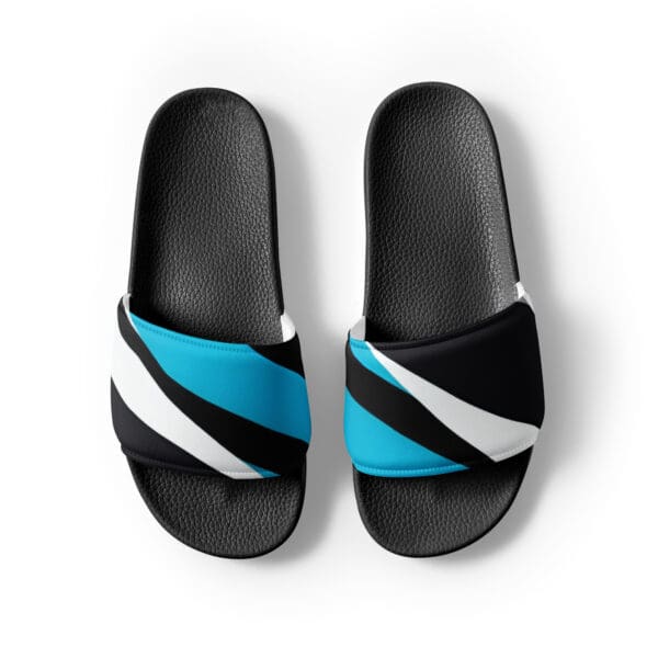 A pair of black and blue sandals on top of a white surface.