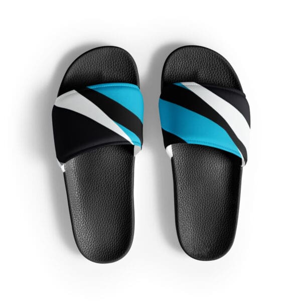 A pair of black and blue sandals on top of a white surface.