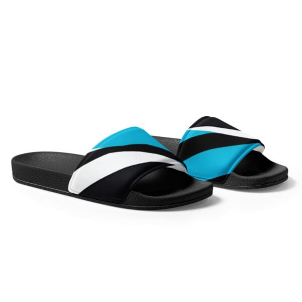 A pair of blue and black sandals on top of a white background.