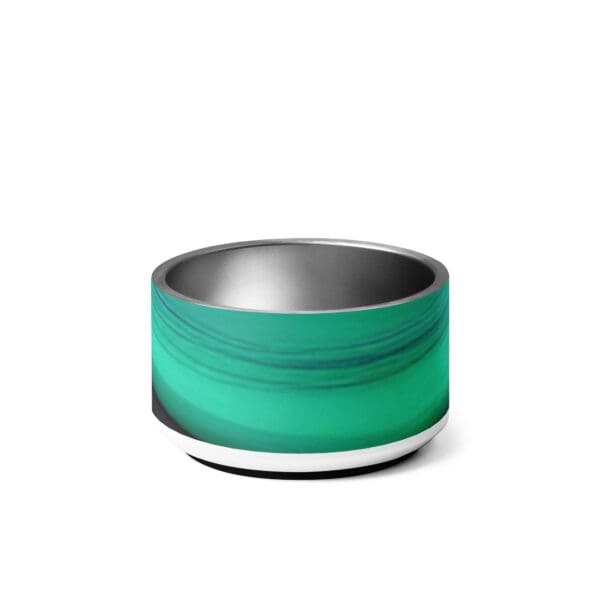 A green bowl with a metal rim on top of it.