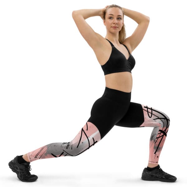 A woman in black and pink sports bra doing yoga.