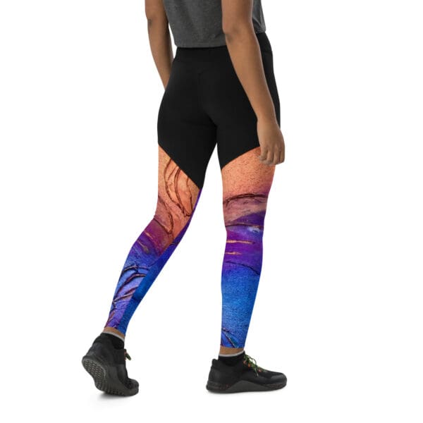 A person wearing leggings with an image of the ocean on them.