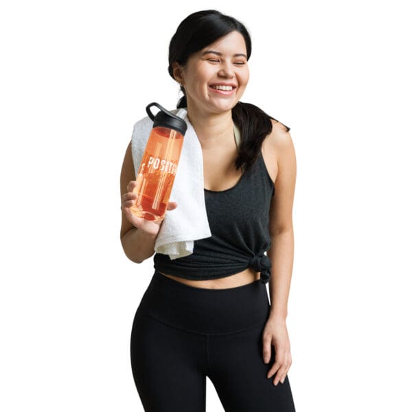 A woman holding onto an orange water bottle