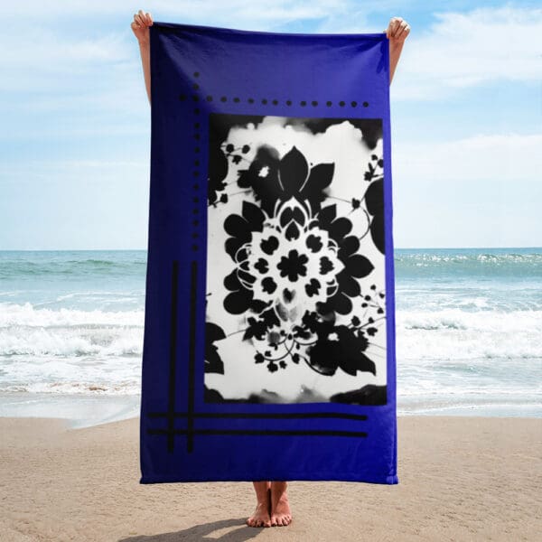 A person standing on the beach holding up a towel