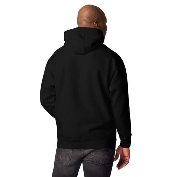 A man wearing a black hoodie with a white logo.