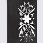 Black cloth with intricate white floral design.