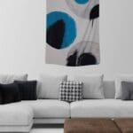 Abstract wall art above a modern couch.
