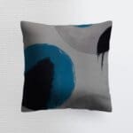 Abstract decorative pillow with blue circles.