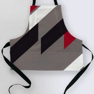 Geometric patterned kitchen apron with ties.