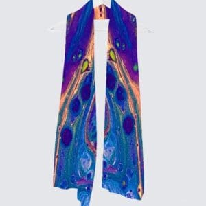 Vibrantly patterned scarf hanging on a hanger.