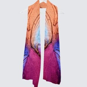 Colorful scarf displayed on a hanger.