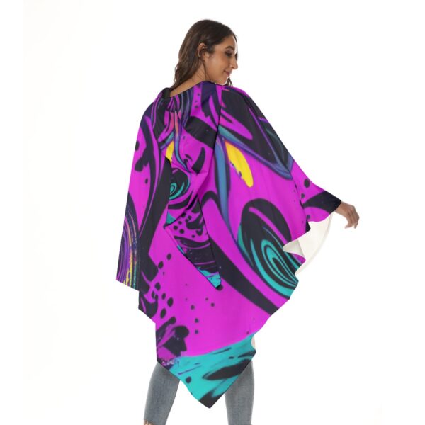 Woman in abstract print hooded poncho.