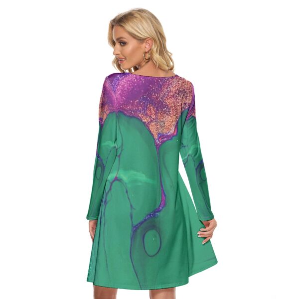 Woman in green abstract print dress.