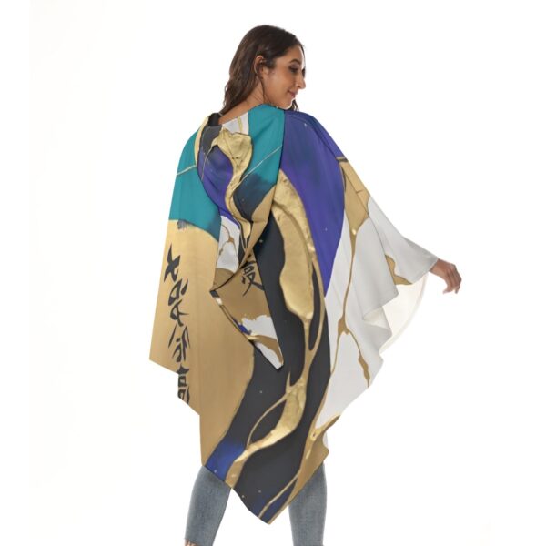 Woman in abstract print hooded poncho.