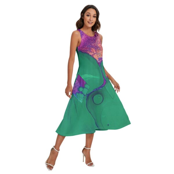 Woman in sleeveless green abstract print dress.