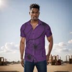 Man wearing a purple patterned shirt outdoors.