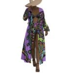 Woman in patterned maxi-dress and hat.