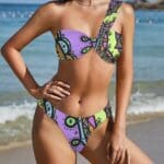 Woman in colorful one-shoulder bikini.