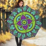 Woman with colorful mandala umbrella, autumn background.