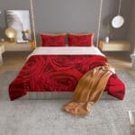 Red rose-patterned bedspread in modern bedroom.