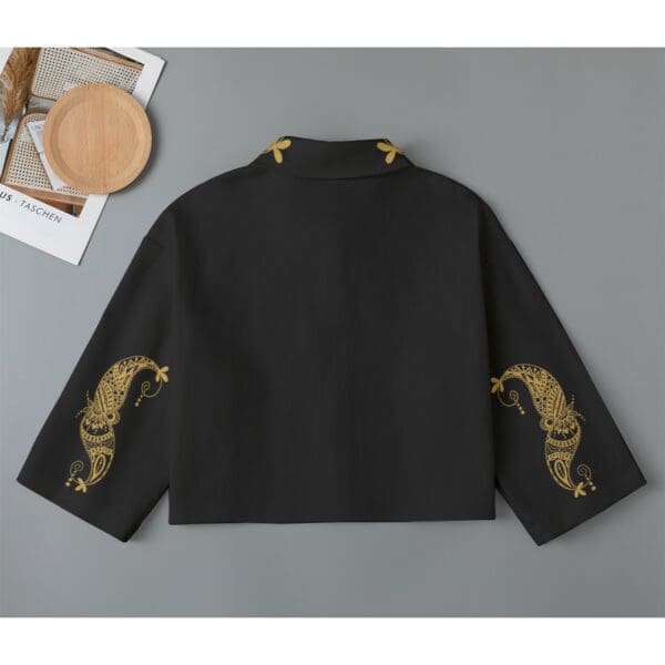 Black shirt with gold paisley sleeves.