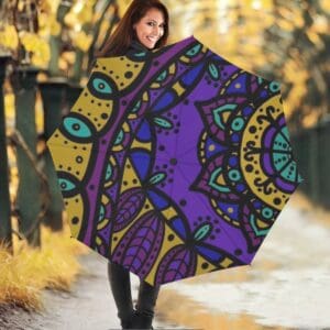 Woman with colorful patterned umbrella outside.