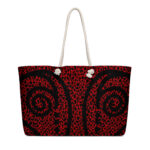 Red tote bag with black swirl pattern.