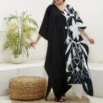 Woman wearing black and white floral dress.