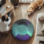 Man working at desk, dog nearby on floor.