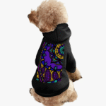 Dog wearing colorful patterned hoodie sitting.