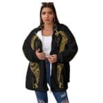 Woman in black jacket with gold patterns.