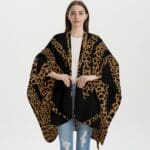 Woman wearing leopard print shawl, casual outfit.