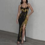 Woman in black and gold floral dress.