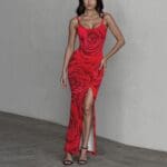 Woman in red floral dress posing confidently.