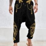 Man wearing black pants with gold designs.