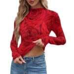 Woman wearing red rose-patterned top, jeans.