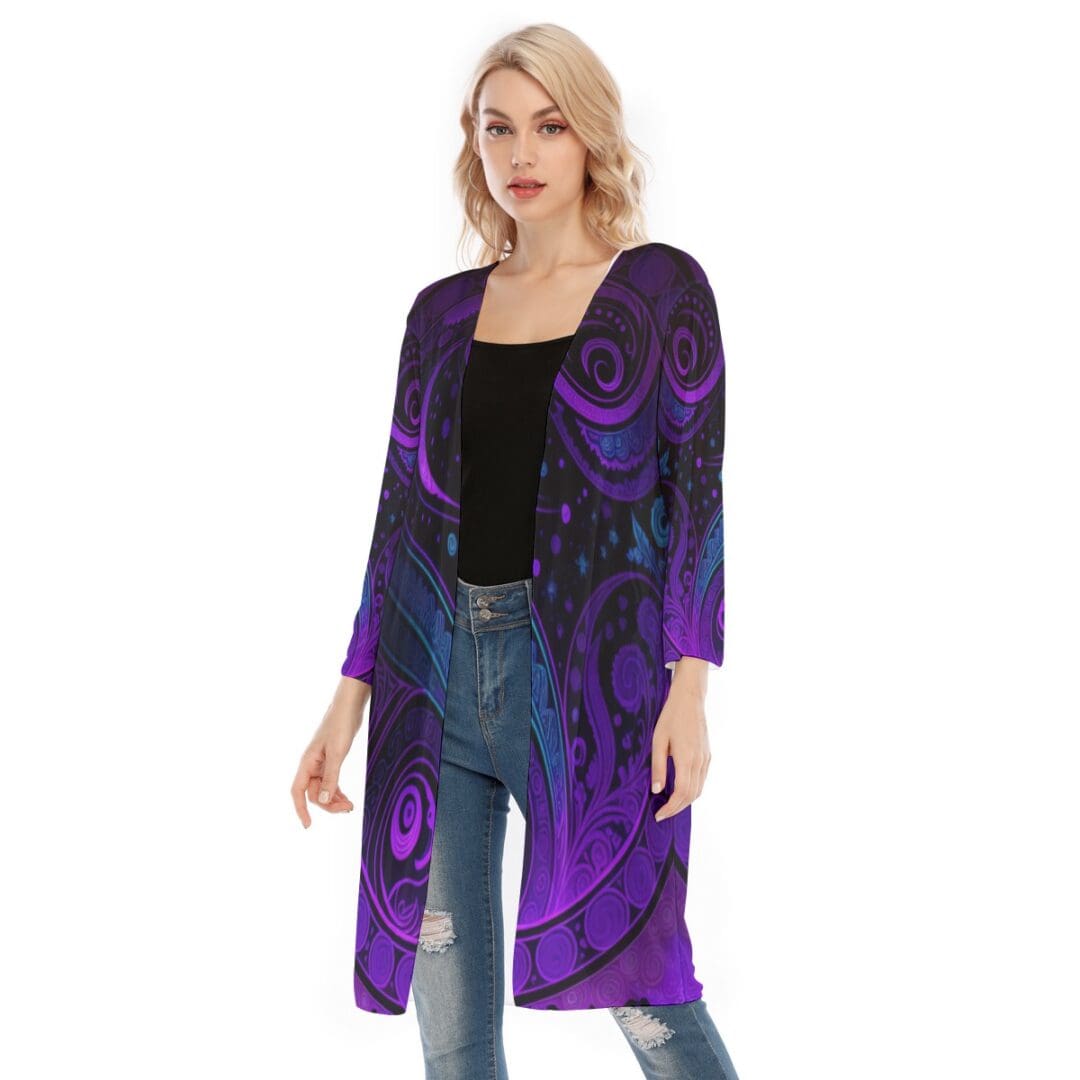 Woman wearing purple-patterned long cardigan.