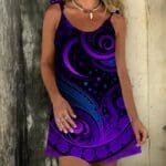Woman wearing a purple patterned dress.