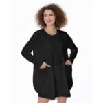Woman in black dress with pockets.