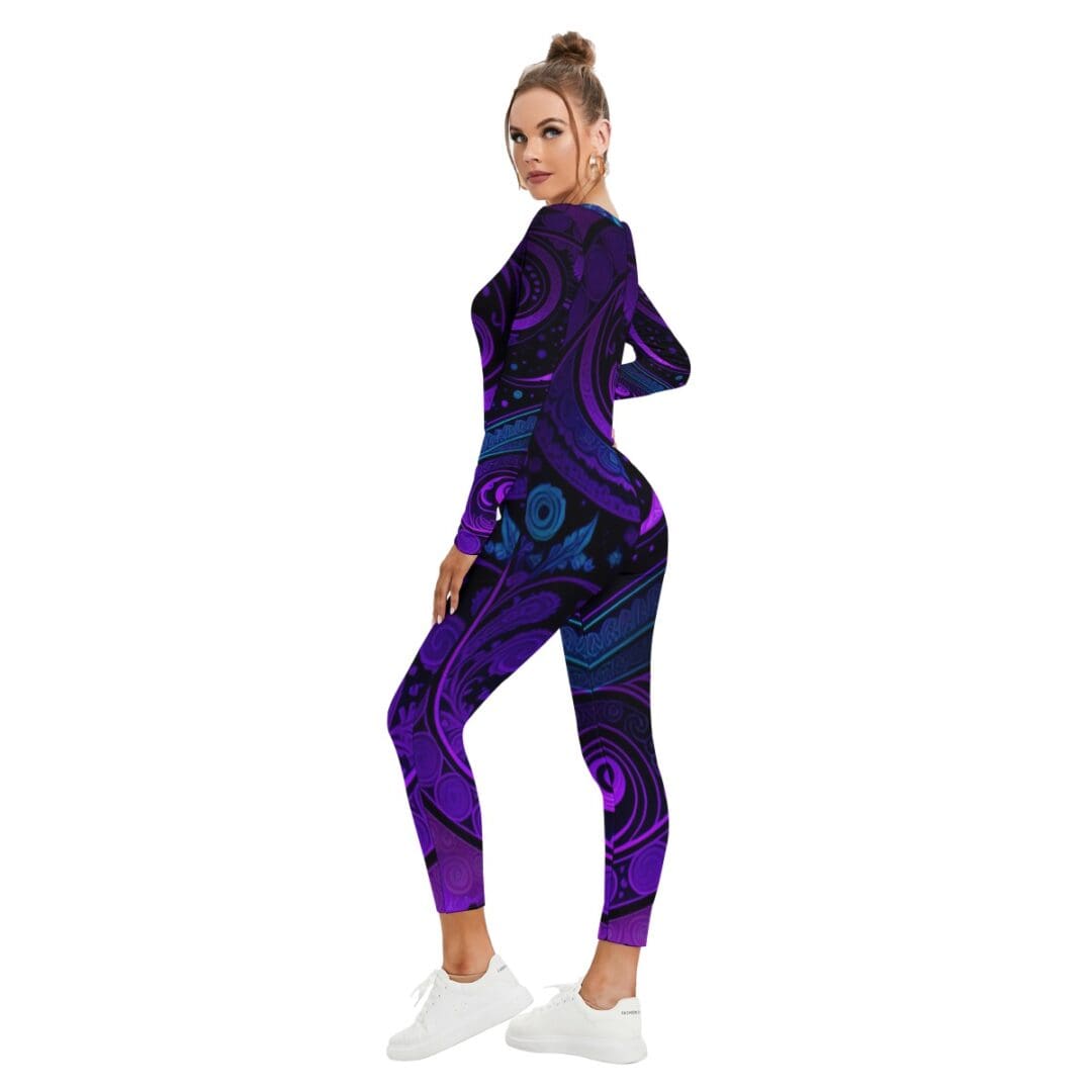 Woman in purple patterned jumpsuit, sneakers.