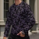 Man wearing patterned purple long-sleeve shirt.