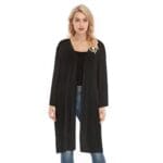 Woman modeling long black cardigan, casual outfit.